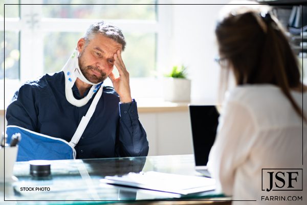 An injured man talks to his lawyer about settling a car accident claim.